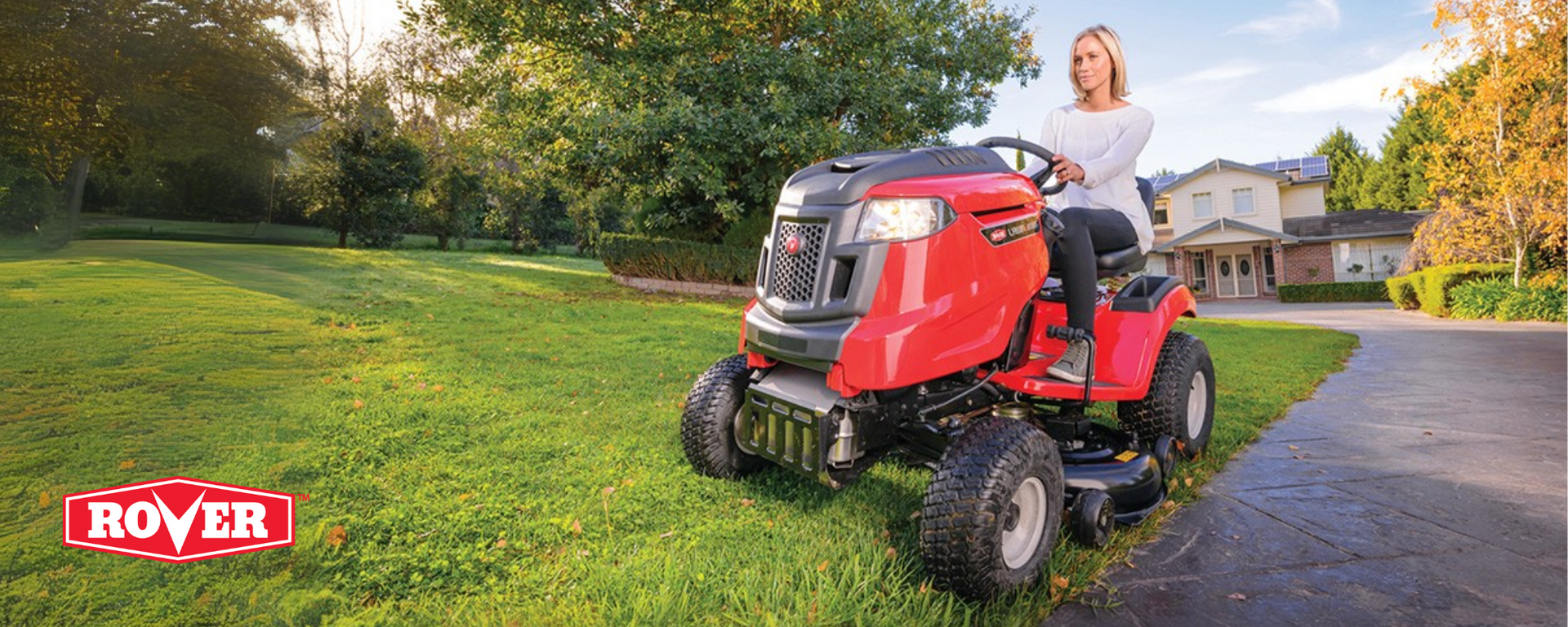 Woman using Rover Rancher ride-on mower on a large residential block – available now at Mower City Albury for EOFY pre-order and pickup
