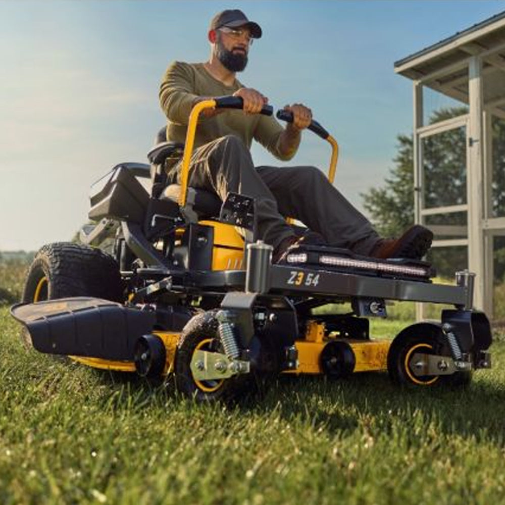 Man operating a Cub Cadet Z3 54 Zero Turn Lawn Mower on grass with a clear sky. Mower City Albury