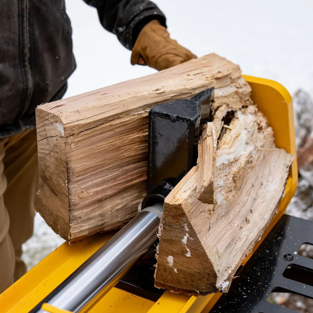 Person using DEWALT 28 ton hydraulic log splitter with Kohler 196cc engine and 13-second cycle time. Built for firewood and heavy splitting. Available at Mower City Albury.