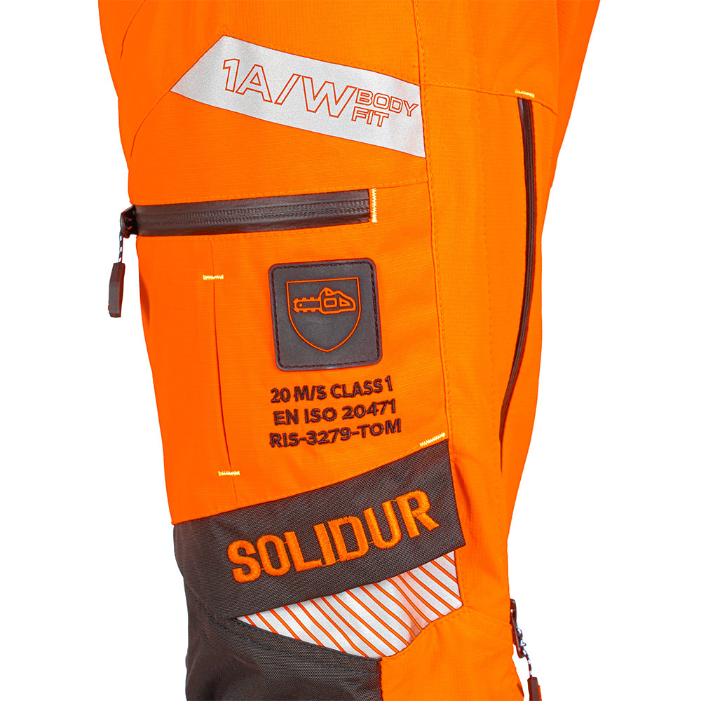 close up detail of Solidur Premium hi-vis orange Class 1 Design A chainsaw trousers. 6-layer protection, 1.35 kg, slim fit, SRT-ready. Available at Mower City Albury.