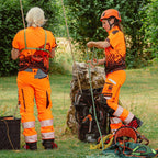 Two arborists wearing Solidur Premium hi-vis orange Class 1 Design A chainsaw trousers. 6-layer protection, 1.35 kg, slim fit, SRT-ready. Available at Mower City Albury.