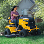 A woman driving a Cub Cadet Enduro XT2 LX 46 K ride-on mower with 24HP Kawasaki engine, 46-inch fabricated deck and diff lock, suited to properties up to 5 acres. Talk to the team at Mower City Albury. 