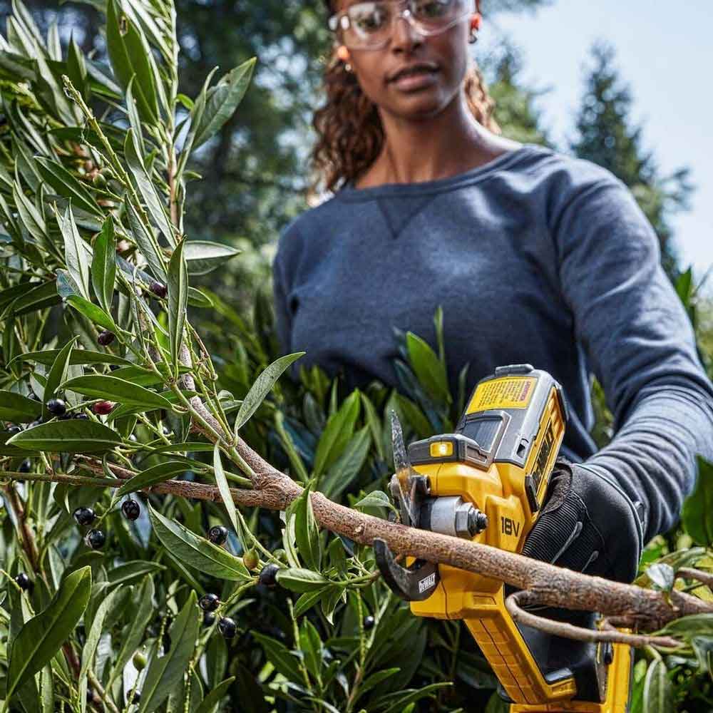 DEWALT 18V XR Power Pruner DCPPP568N-XE – cordless secateur with 32 mm cutting capacity, LED light and ergonomic handle. Skin only. Available at Mower City Albury. Pruner in use