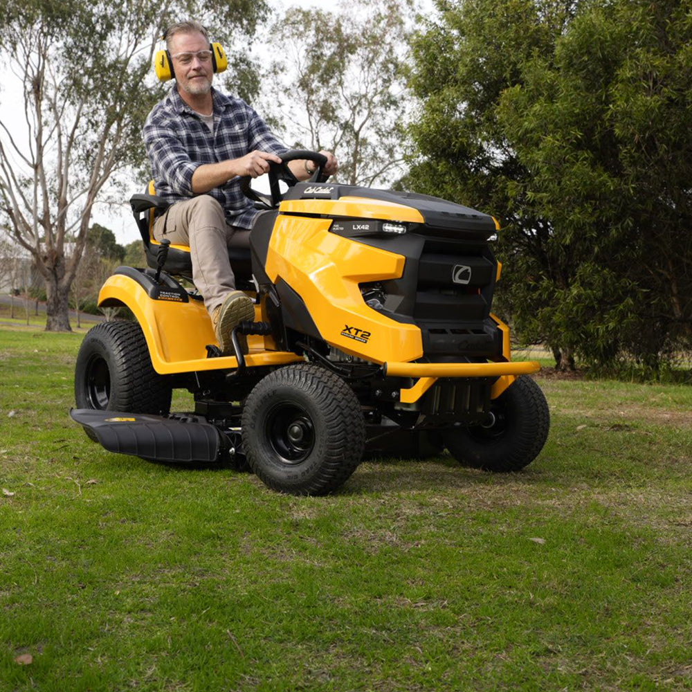 A man riding a Cub Cadet Enduro XT2 42 K ride-on mower with 21.5HP Kawasaki V-Twin engine and 42-inch fabricated deck, suited to large blocks and small acreage. Mower City Albury - up to four acres