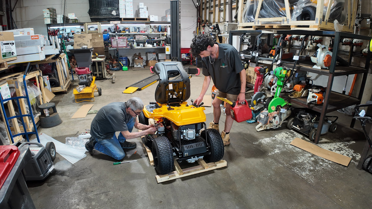 Two men working on a Cub Cadet Lawn Mower at Mower City Albury. Service, repairs and expert knowledge. 