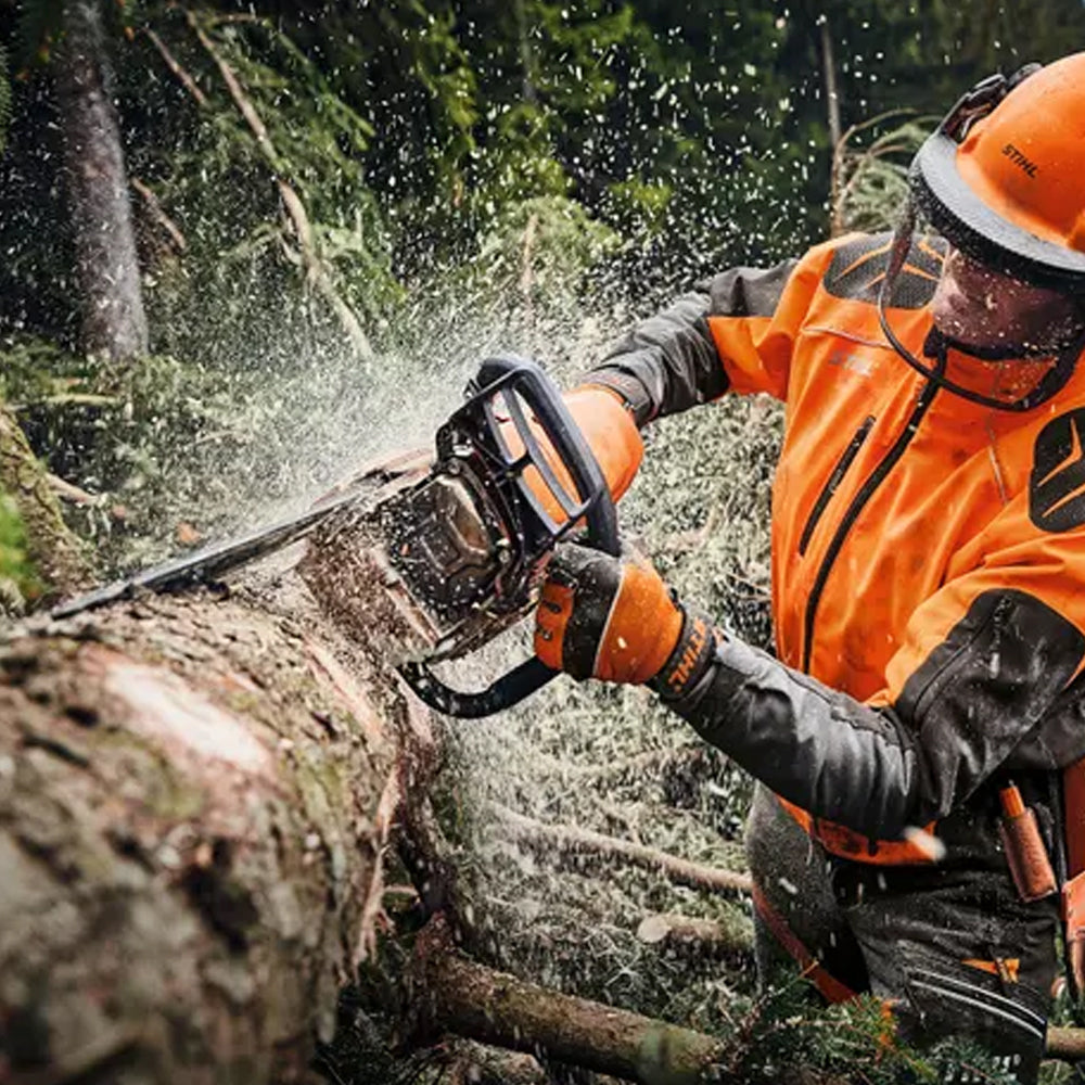 Person cutting a log with a STIHL 462 CM Petrol Chainssaw in forest setting - Mower City Albury 